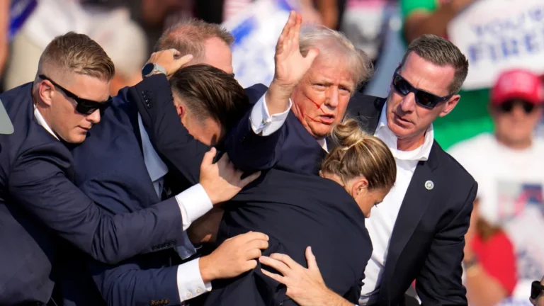 Shots were fired at Donald Trump, leaving blood visible on his face.